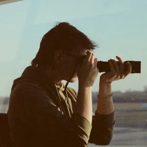 Photo of rail's profile while they take a photo on analog camera